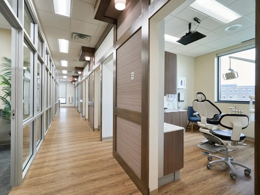 The treatment corridor at Woodbury Dental Care, with a treatment room open beside a window.