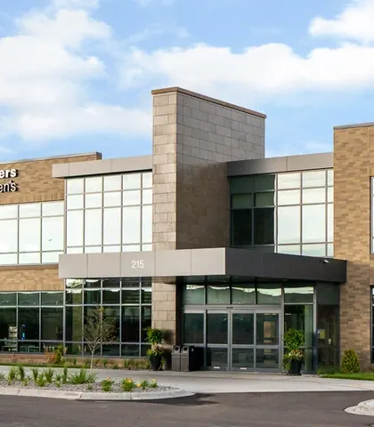 The building at 215 Radio Drive, Woodbury, on a summer day.