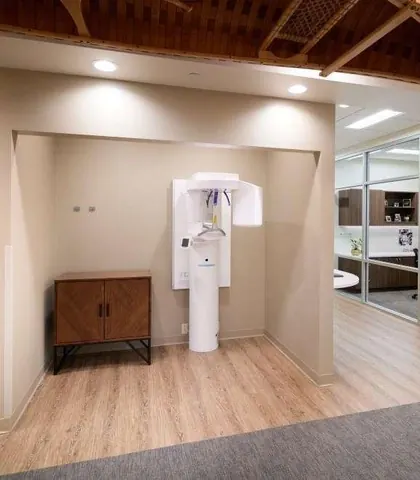 The imaging alcove with the 3-D cone beam unit, a treatment room to one side.