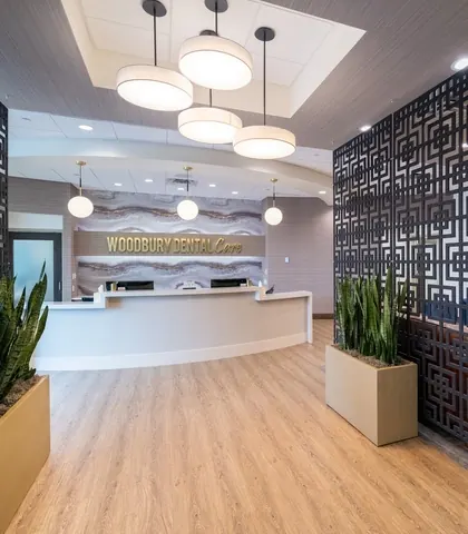 The reception desk, with the practice's name in gold lettering on a stone-patterned wall.